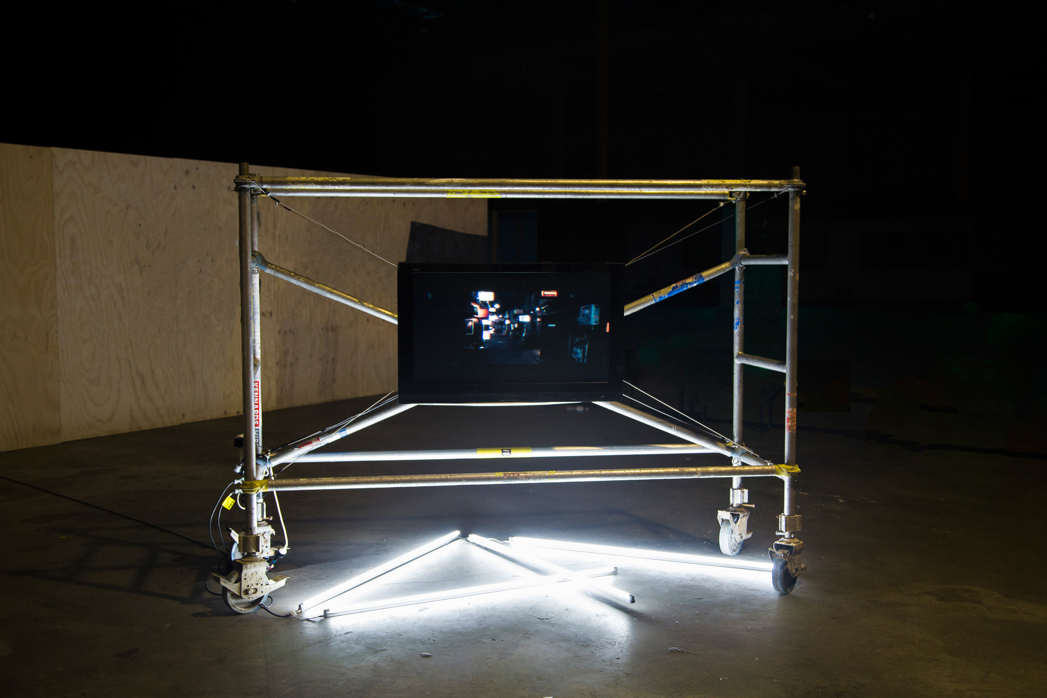 <p><i>Metropolis</i>, 2016, Single channel HD video, Continuous Loop 2:40 mins. LCD Screen 1200mm x 800mm, Scaffolding, Metal Rope, Fluro Bar. Installation view, Sydney Fringe Festival, 2017. </p>